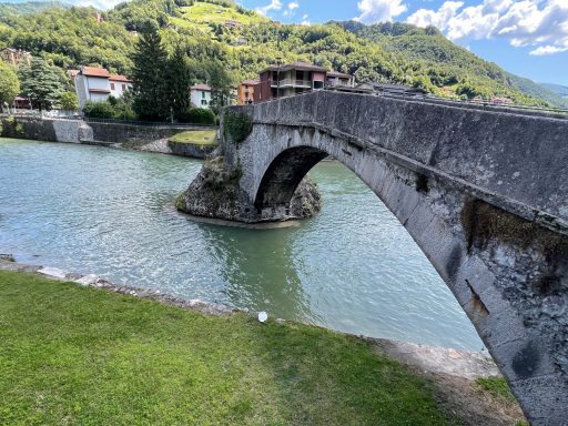 Old stone arch bridge over the River Brembo at San Pellegrino Terme, Italy